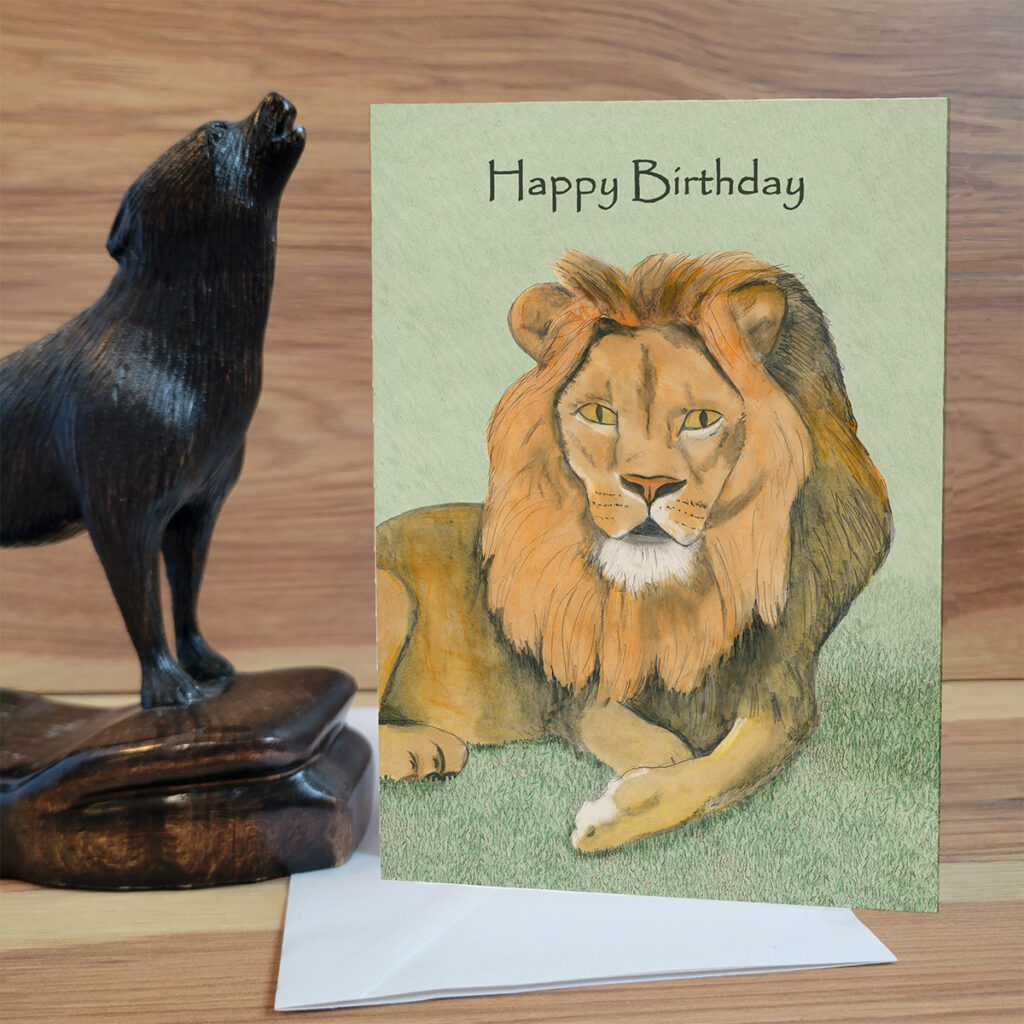 Lion lounging in the grass Birthday Card