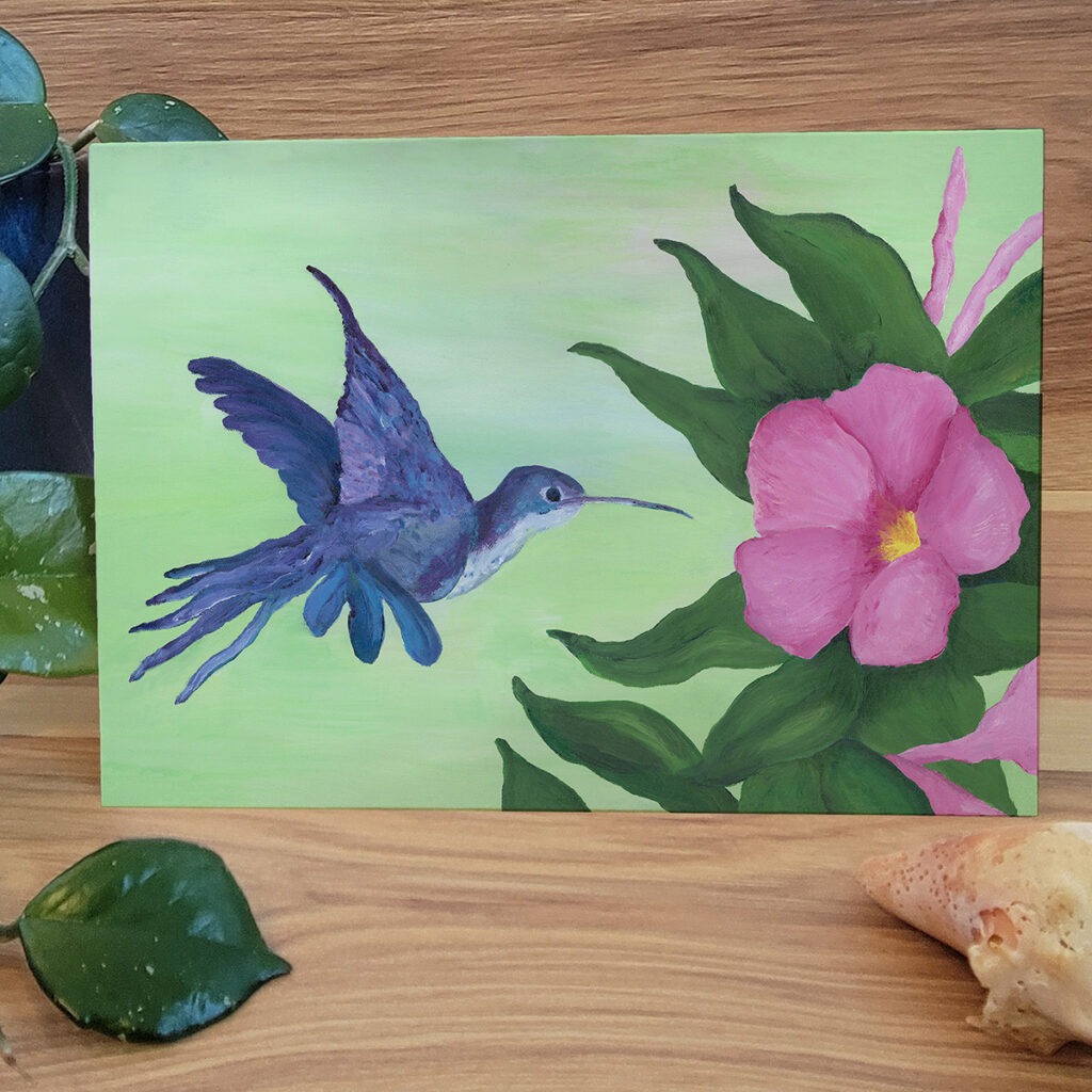 Hummingbird hovering around a pink flower greeting card